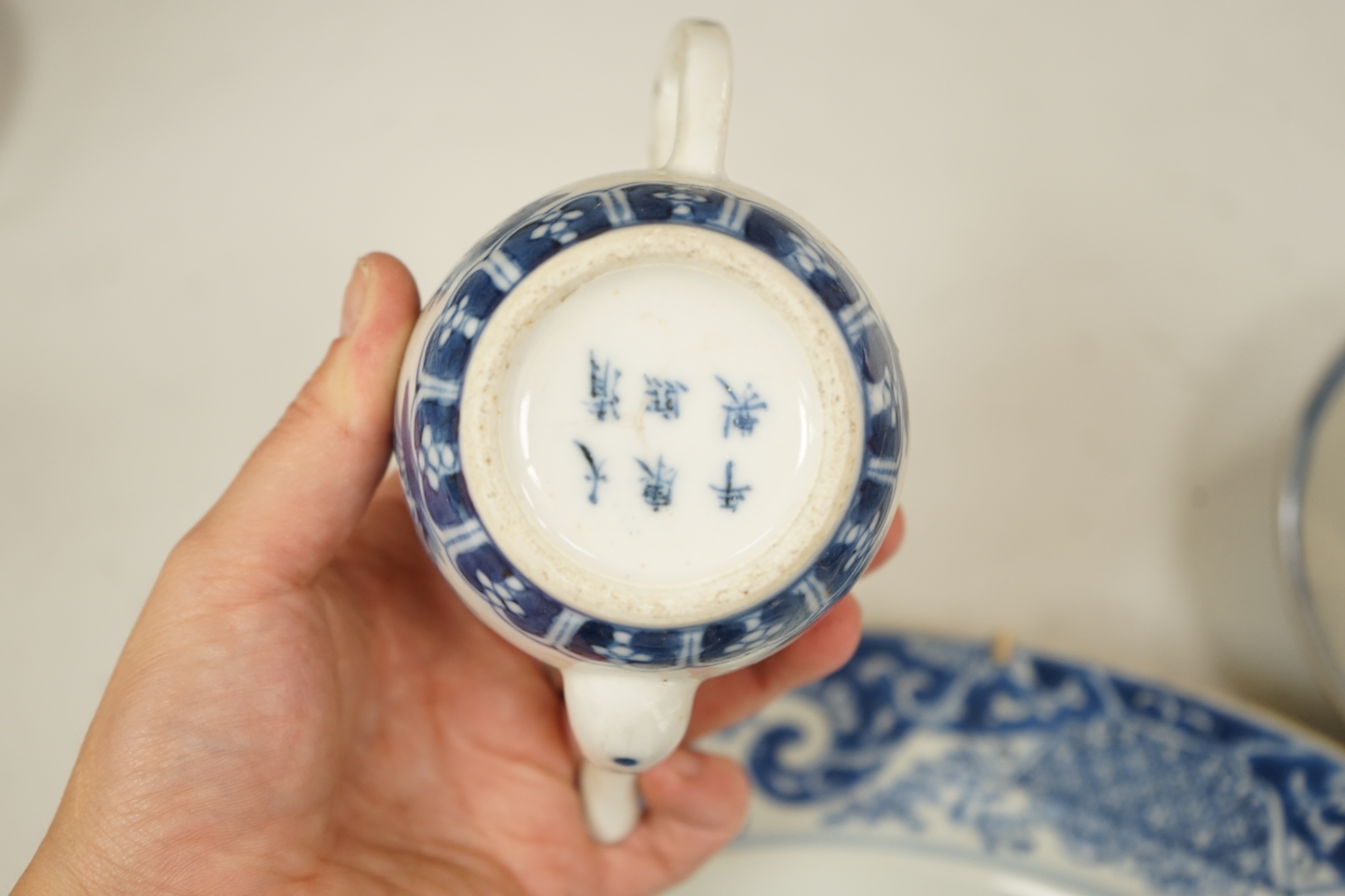 A Worcester teapot, c.1770, two 18th century Chinese porcelain dishes, a cup and saucer, a Chinese shallow bowl and a small teapot, largest dish 39cm